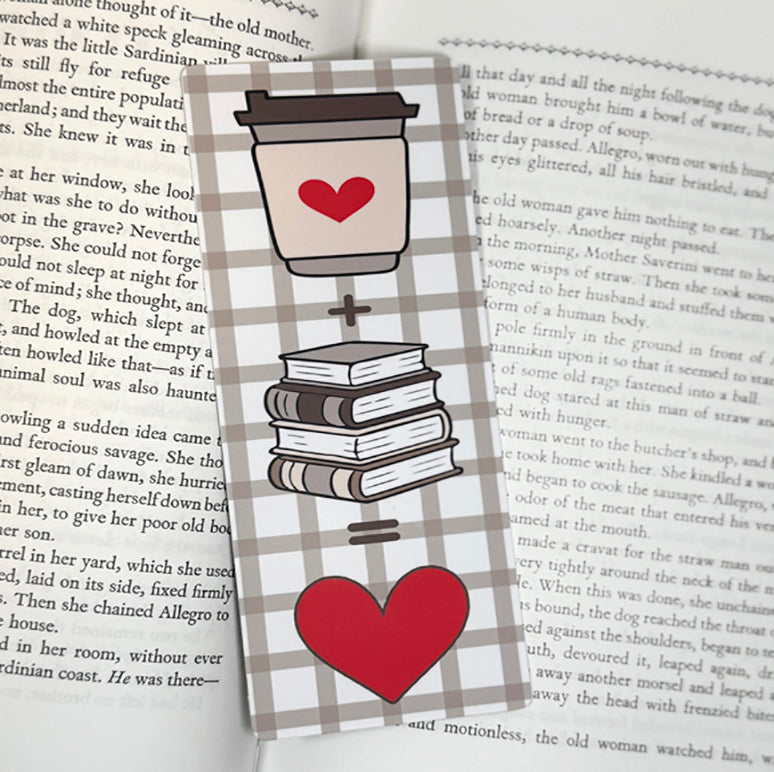 “Classic bookmark with coffee cup, books, and heart equation on a neutral plaid background placed on pages of an open book.”