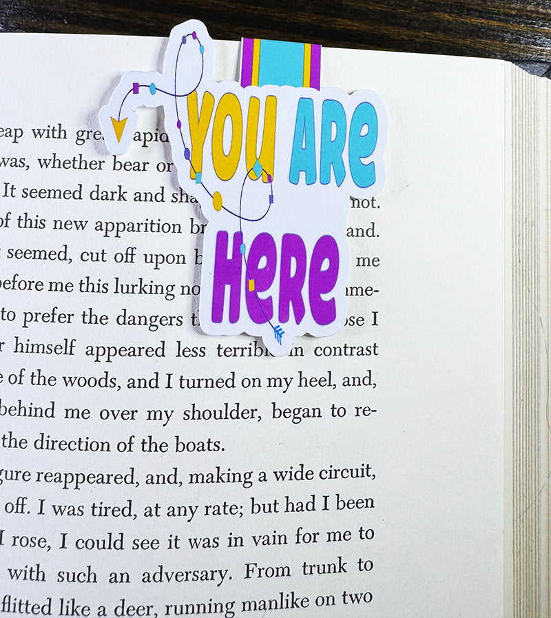 Colorful magnetic bookmark with “You Are Here” text and arrow path design