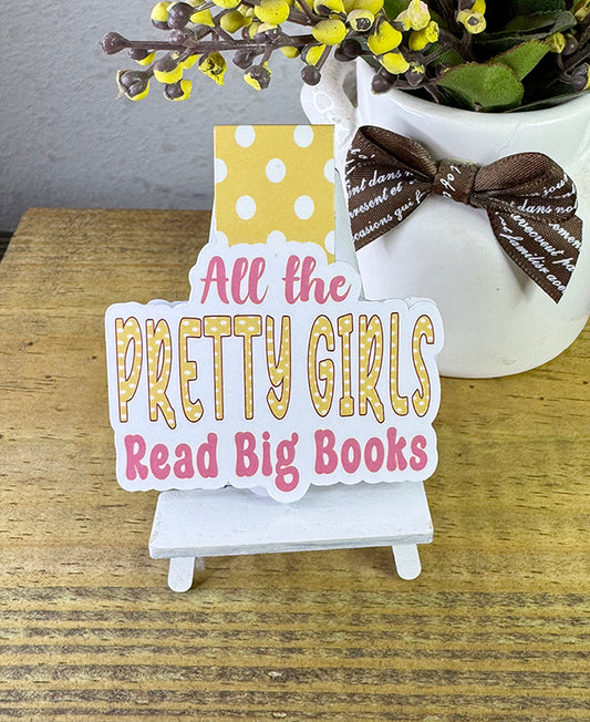 Magnetic bookmark with “All the Pretty Girls Read Big Books” in pink and yellow with polka dot background
