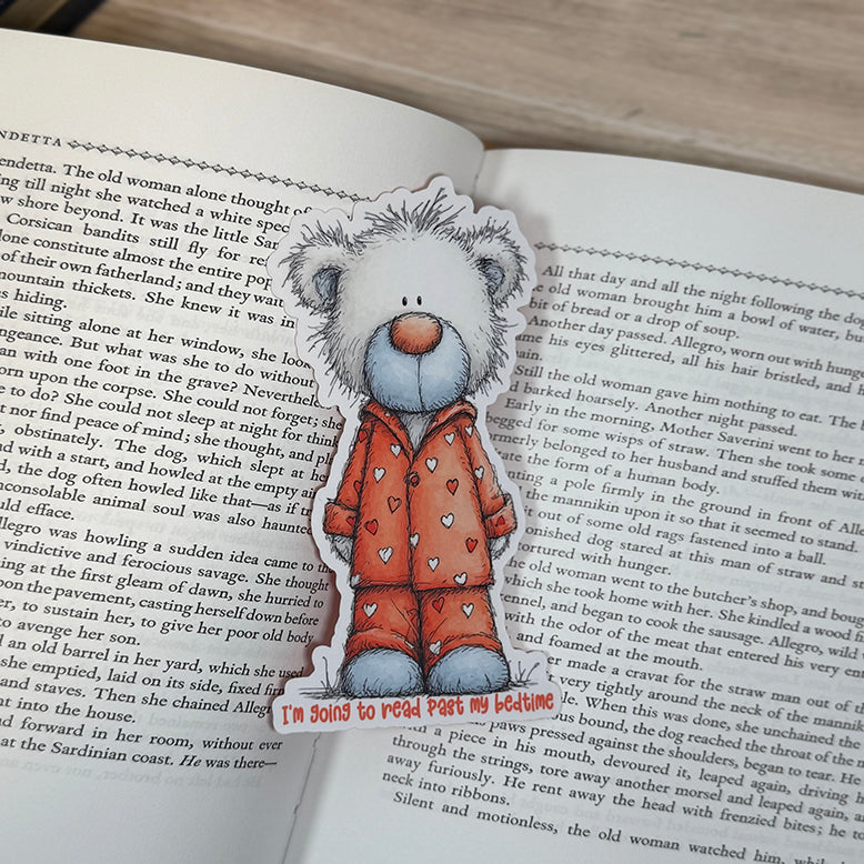 “Teddy bear soft-touch classic bookmark placed between the pages of an open book, showcasing cute pajamas and bedtime reading theme.”
