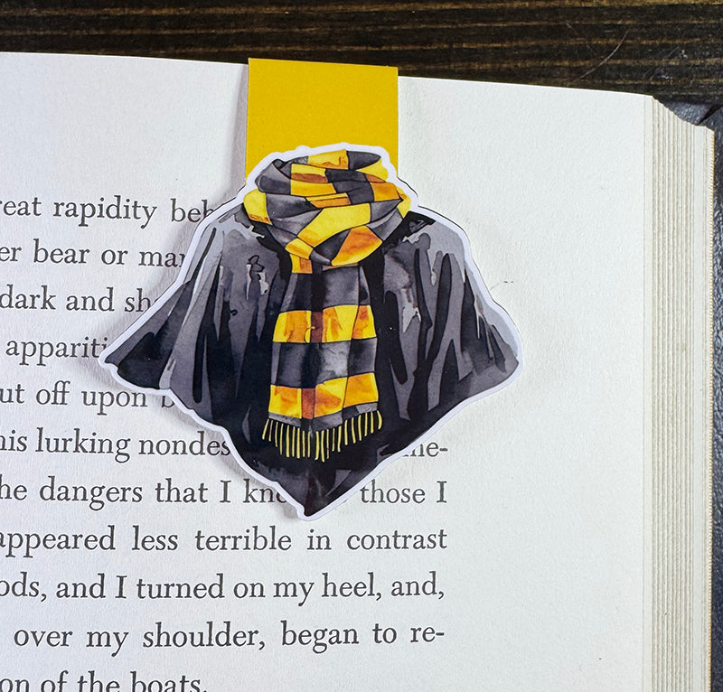 Wizard robe magnetic bookmark with black cloak and yellow-striped scarf on yellow tab background