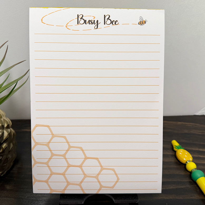 5x7 Busy Bee notepad with lined pages, bee illustration, and honeycomb corner design – cute golden stationery for notes and daily lists.