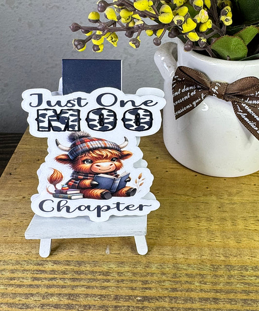 “Cute Highland cow magnetic bookmark with book and plaid beanie that says 'Just One Moo Chapter'”