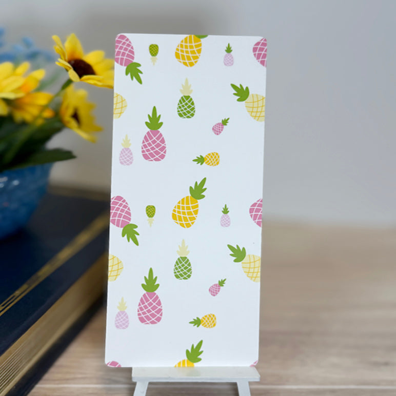 “Back of tropical bookmark featuring colorful pineapple pattern in pink, yellow, and green.”