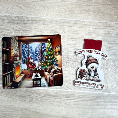“North Pole Book Club magnetic bookmark with Christmas bear and cozy fireplace backing card flat lay.”