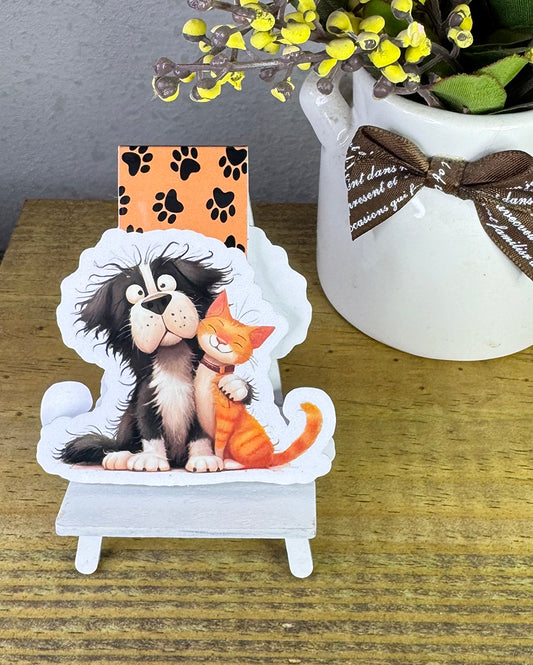 Magnetic bookmark with cute black dog and orange tabby cat hugging, on paw print background