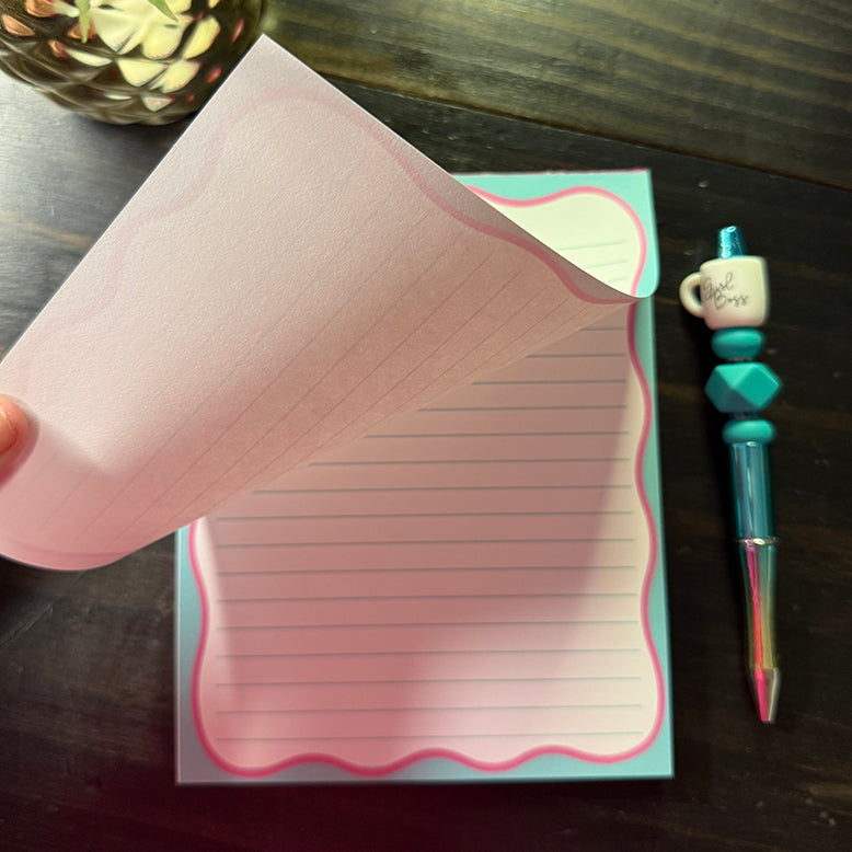 Close-up of a single sheet being lifted from the Pink Bow Notes Notepad, showing the tear-off design and pink scalloped border detail.