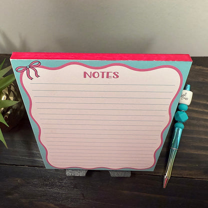 Top-down view of Pink Bow Notes Notepad with pink bow illustration and lined pages, ideal for planners and stationery lovers.